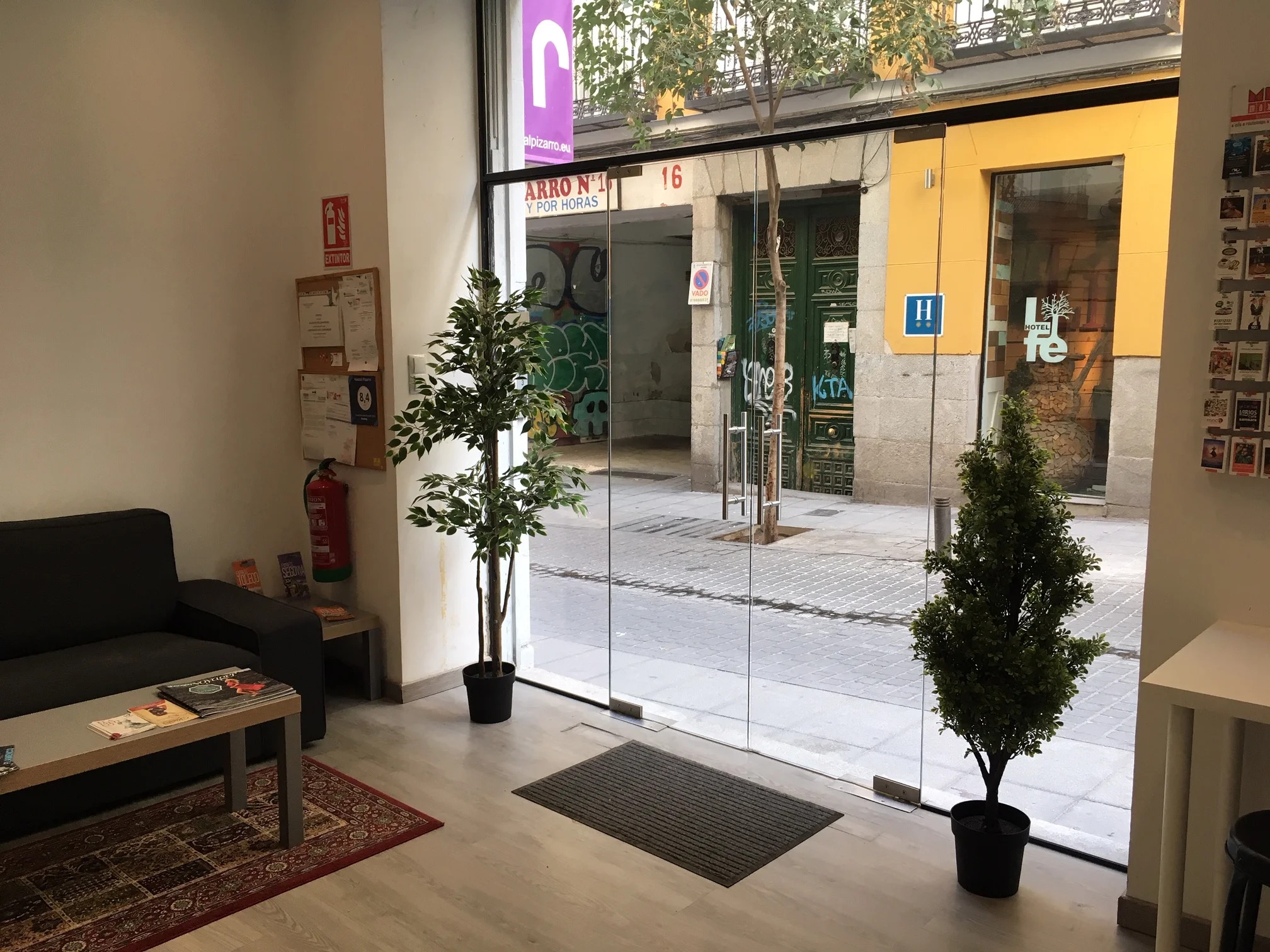 Reception area with glass entrance door and full-height windows